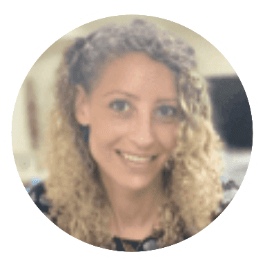 Smiling woman with curly blonde hair in a circular frame.